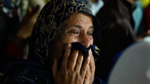 A woman cries as she waits at a primary health centre in Meppadi in Kerala's Wayanad district in India on July 30, 2024