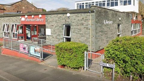 A general view of Ulverston Library, a small stone building, seen from the street