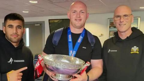 Arun Watkins, Carl Forster and Bobby Watkins celebrate Crusaders' title win