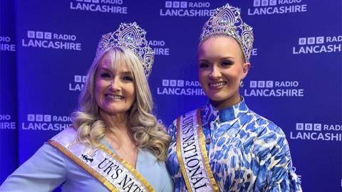Dawn, with long blonde curly hair and Eden Ronson with her hair swept back, both wear their crowns and sashes.