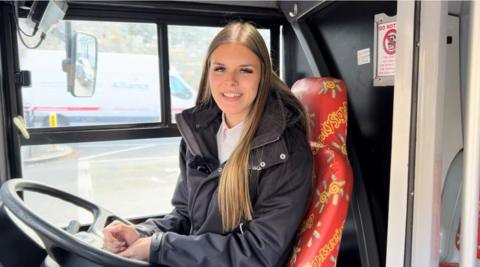 Emma Pool-Long sits behind the wheel of the bus she drives in York.