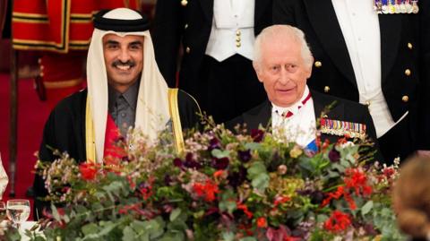 Qatari Emir Sheikh Tamim bin Hamad Al Thani and King Charles sitting at the state banquet in Buckingham Palace on 3 December 2024