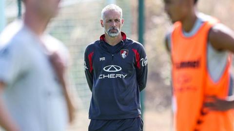 Head coach Marco Rose of Bournemouth looks on wearing a blue tracksuit top