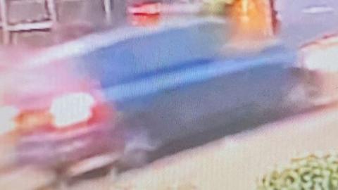 A blurry picture of a car, potentially a dark green Ford Galaxy which police are looking for 