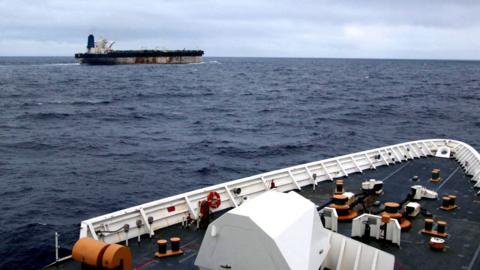 The shadow fleet ship Marinera seen in the distance from the upper decks of a US coastguard cutter following her.
