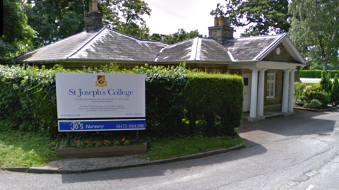 The front entrance to St Joseph's College. A sign saying 'St Joseph's College' can be seen on the left of the image