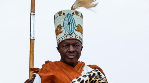 A man carries Kabaka (King) Ronald Muwenda Mutebi II on his shoulders during his 30 year coronation at his palace in Mengo, Kampala, on July 31, 2023.