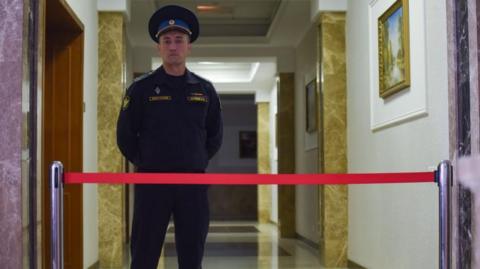 A bailiff stands guard in the court during hearing a case against the Wall Street Journal (WSJ) correspondent Evan Gershkovich in Yekaterinburg's Sverdlovsk Regional Court