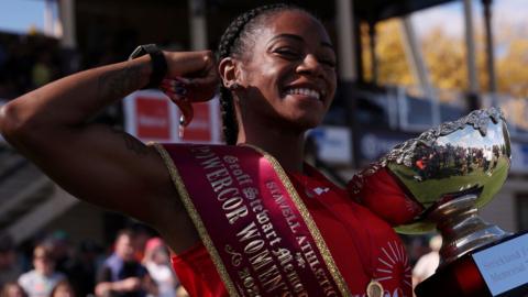 Sha'Carri Richardson celebrates with her trophy after winning the Stawell Gift