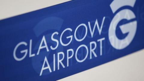 A sign showing the Glasgow airport logo
