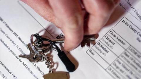 Jose Da Costa Diogo holds his keys before handing them over to the bailiffs