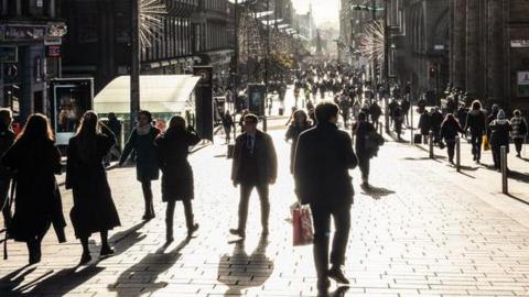 A sunlit view of Buchanan Street in Glasgow.