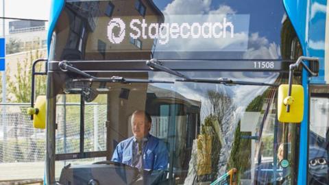 A photo of a blue and white Stagecoach bus at a stop