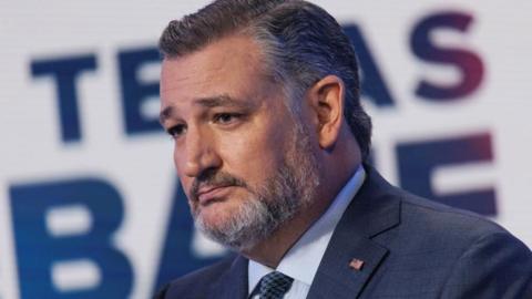 A closeup photo of Texas Senator Ted Cruz, who is wearing a blue suit