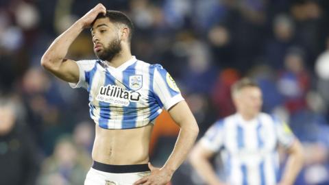 Huddersfield full-back Brodie Spence reacts after their 1-0 home defeat by fellow promotion hopefuls Wrexham on Tuesday