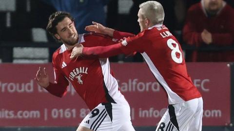 Salford striker Cole Stockton celebrates scoring against Harrogate