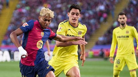 Barcelona's Yamine Yamal competing for the ball with Villarreal's Sergi Cardona during a La Liga match last season.