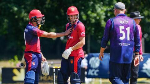 Nick Greenwood and Zak Tribe celebrate a boundary against Scotland