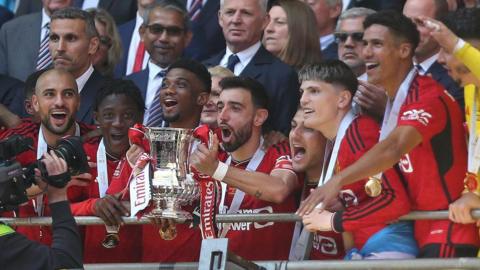 Manchester United captain Bruno Fernandes lifts the FA Cup aloft at Wembley Stadium 