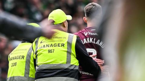  Hearts' Lawrence Shankland with stewards at full time during a William Hill Premiership match between Celtic and Heart of Midlothian at Celtic Park, on May 16, 2026, in Glasgow, Scotland.