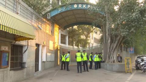 Security officials are standing outside Delhi Public School, RK Puram, which was among the schools that received a bomb threat email on 8 December.