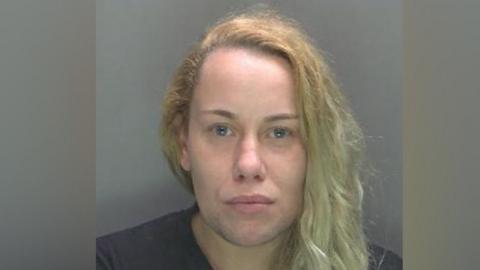 A mugshot of Lindsey Melvin, who is staring directly into the camera. She has long blonde hair and blue eyes. 