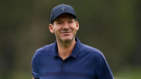 Romo seen wearing a hat outside while golfing