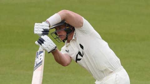 Jamie Smith batting for Surrey, hitting a shot down the ground