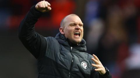 Bristol City head coach Liam Manning raises his fist in celebration