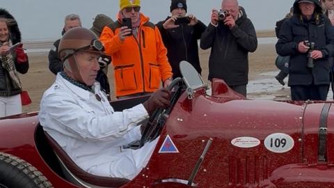 RAF fighter pilot Wing Cdr Andy Green, driving the red Sunbeam Tiger