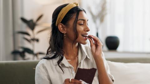 Woman eating a chocolate bar