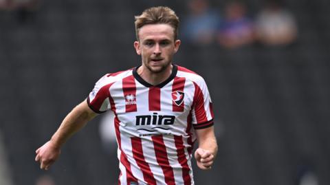 Darragh Power running on the pitch during a match for Cheltenham Town