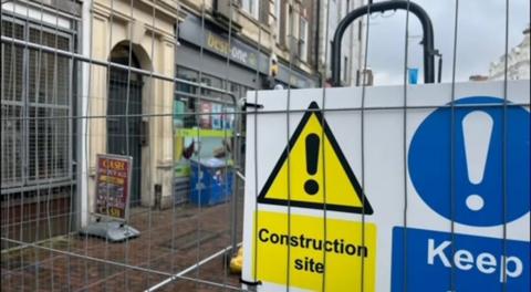 Roadwork barriers block a pedestrianised area of Eastbourne, East Sussex 