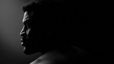 Francis Ngannou's face in shadow