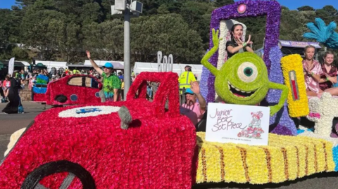 A float at a Battle of Flowers event in Jersey. It is covered in flowers with a designed based on the film Monsters Inc, with the character Mike featuring.