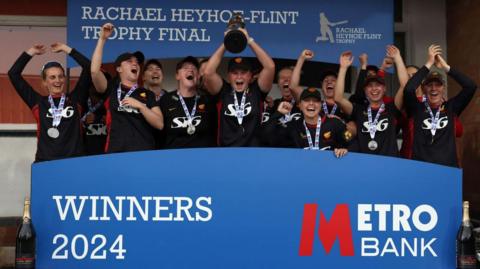 Sunrisers captain Grace Scrivens lifts the Rachael Heyhoe Flint Trophy