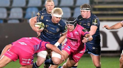 Aaron Wainwright of Dragons is tackled by Leonardo Krumov of Zebre