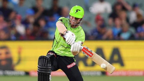 David Warner hits the ball with his bat playing in the Big Bash League
