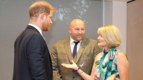 Rhian Greenslade talking to Prince Harry at awards ceremony