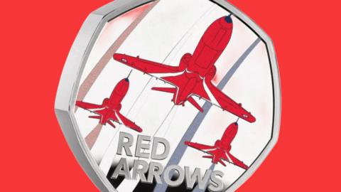 Red arrow design on a 50p coin.