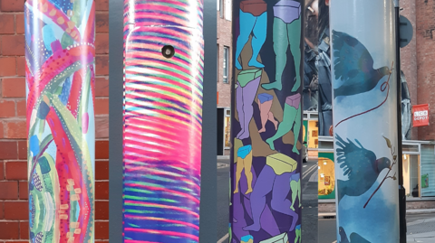 A composite of four bright designs on lampposts