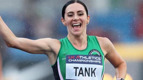Poppy Tank raises her arm in celebration