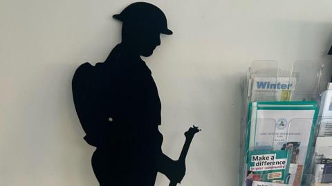 A silhouette statue of a World War One Tommy. The bayonet at the top of the gun has been removed