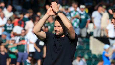 Tom Cleverley applauds the Plymouth fans