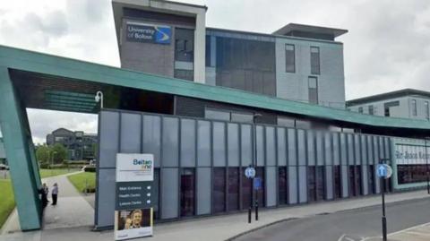 The green and grey exterior of the Sir Jason Kenny Centre at what was then called the University of Bolton.