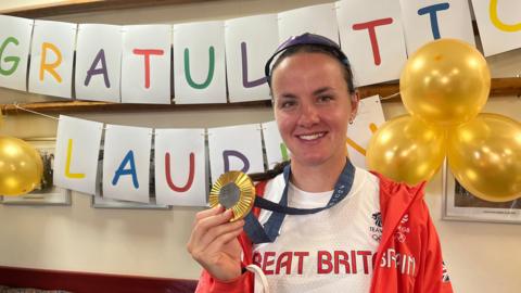 Lauren Henry with her gold medal on her return to Leicester Rowing Club.