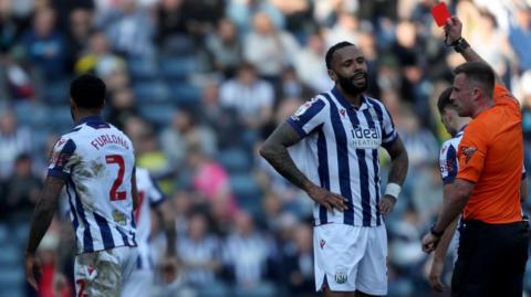 West Bromwich Albion defender Darnell Furlong (left) walks off the pitch after being shown a straight red card against QPR