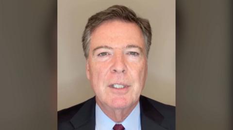 James Comey speaks to the camera.