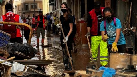 Volunteers and emergency services are working to clean the streets in Paiporta, in Spain, two weeks after the region was hit by deadly floods