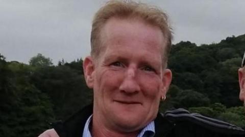 Steven Barry Ellis, who was pronounced dead at the scene after a car crash.
He is smiling and has two hoop earrings in his left ear.
Mr Ellis is wearing a dark top and a shirt with a blue and white patterned collar